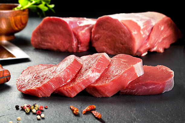 Fresh and raw meat. Sirloin medallions steaks Fresh and raw meat. Sirloin medallions steaks in a row ready to cook. Background black blackboard pork stock pictures, royalty-free photos & images