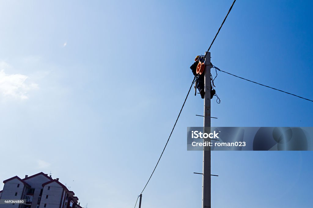 Work on a pole Technician works high up on a power pole. 2015 Stock Photo