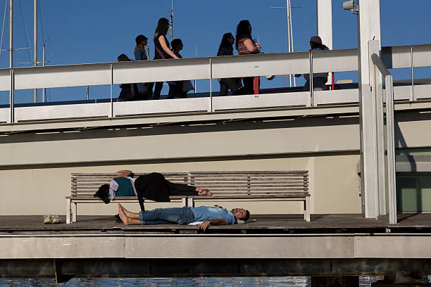 Barcelona - sleeping tourists on Rambla del Mar stock photo