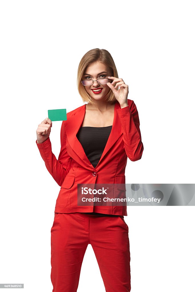 Beautiful smiling business woman wearing spectacles and in the r Beautiful smiling business woman wearing spectacles and in the red, holding a card in hand, isolated on white background 2015 Stock Photo