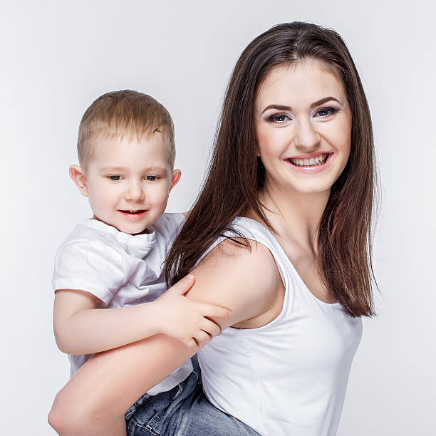 istock happy mother with a child on light grey background 469371346