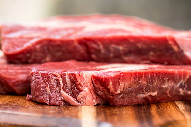 istock Fresh beef steaks on wooden board 469373544