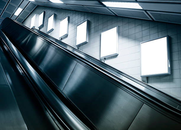 istock Vertical posters on wall above escalator in subway station 469375704