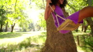 istock Happy Afro girl swinging under sunlit tree slow motion 469375834