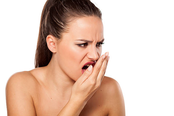 istock woman checking breath 469381786