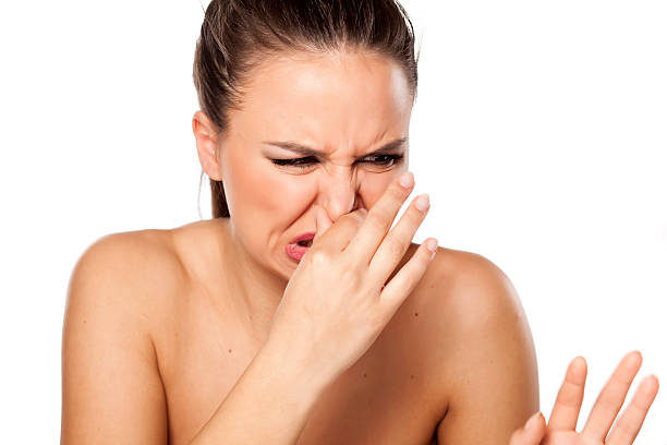 istock woman closes nose 469381788