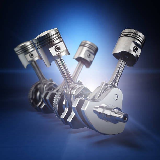 istock V4 engine pistons and cog on black background. 469385464