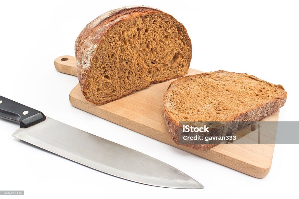 Black homemade bread on wooden board isolated on white Backgrounds Stock Photo