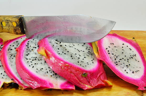 istock dragon fruit and knife on chopping block 469386064