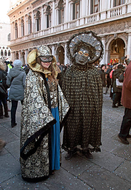 masked persons in costume on Carnival in Venice Venice, Italy - February 8, 2015: Two unidentified masked persons in costume on San Marco Square during the Carnival in Venice, Italy. mardi gras body painting stock pictures, royalty-free photos & images