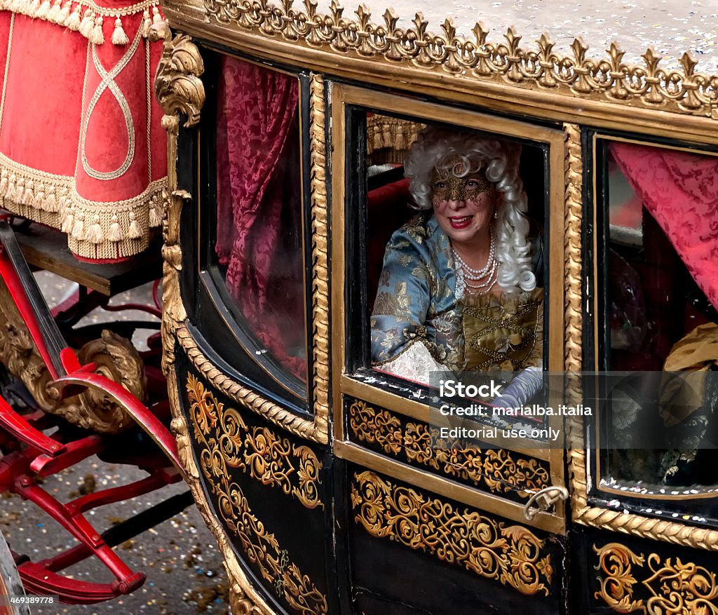 masked dame in a coach Rome, Italy - February 17, 2015: XVIII century style dame in a XVIII century coach during Carnevale Romano's Parade. Carnival - Celebration Event Stock Photo