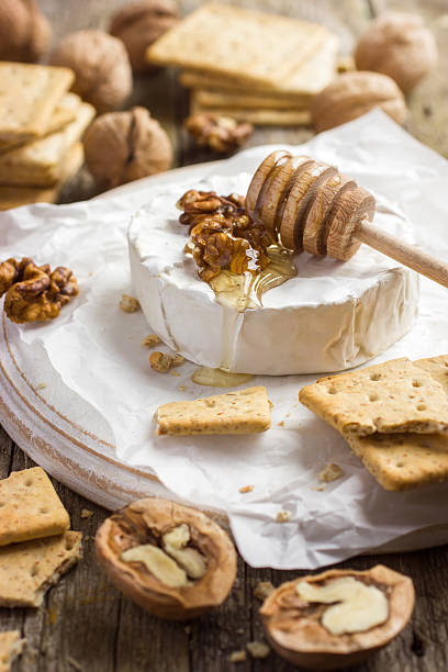 istock camembert cheese with crackers, nuts and honey 469390434