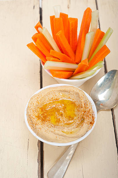 istock fresh hummus dip with raw carrot and celery 469395494