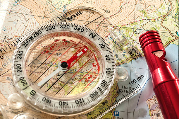 компас на карте и экстренная whistle - orienteering planning mountain climbing compass стоковые фото и изображения
