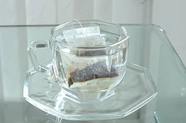 Hot water in cup with tea bag, tea-break