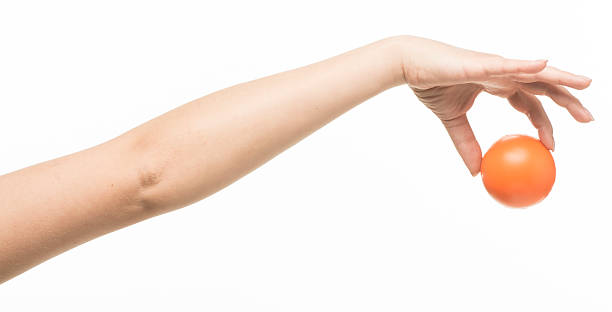 istock female hand with orange sponge ball 469401006