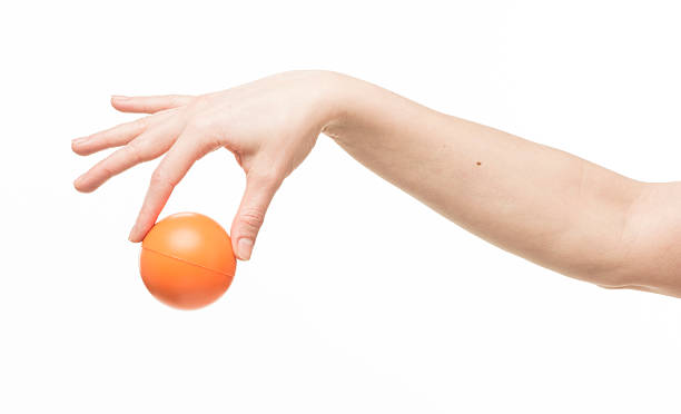 istock female hand with orange sponge ball 469401022