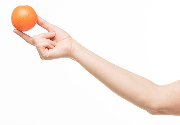 istock female hand with orange sponge ball 469401024
