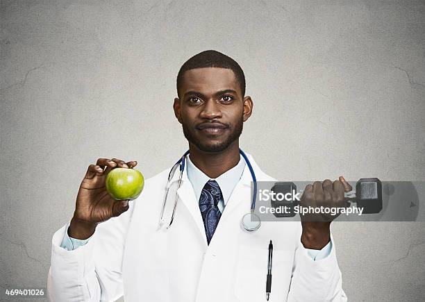 Happy Doctor Holding Green Apple Dumbbell Stock Photo - Download Image Now - Adult, Adults Only, African Ethnicity