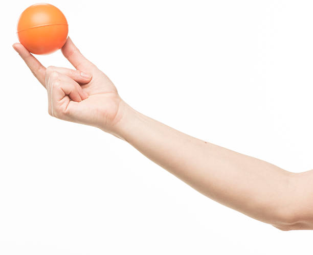 istock female hand with orange sponge ball 469401028