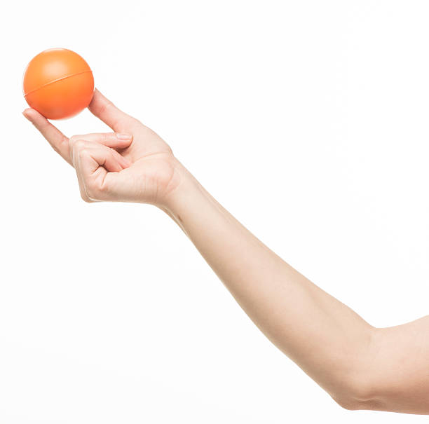 istock female hand with orange sponge ball 469401030