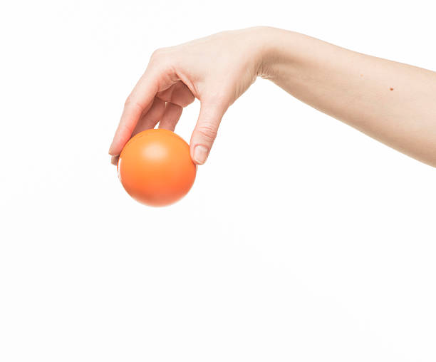 istock female hand with orange sponge ball 469401034