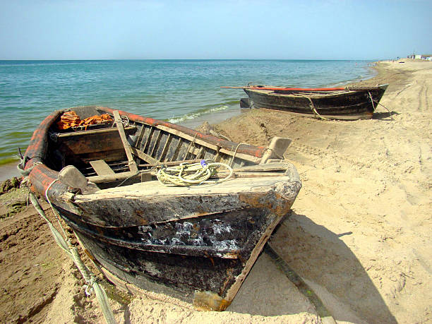 istock Two old wooden boat on the beach 469404734
