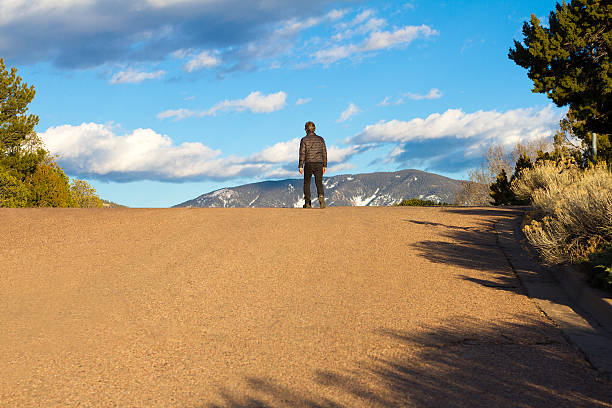 Solitary Man Crests a Hill