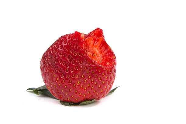 istock Bitten of strawberry on white 469411990