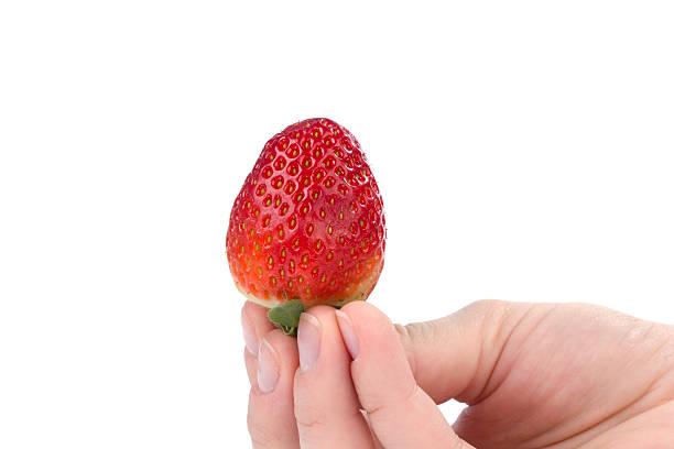 istock Hand holding one strawberry on white 469412296