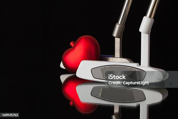 Two Different Golf Putters And Red Heart Stock Photo - Download Image Now - Emotion, Equipment, Fun