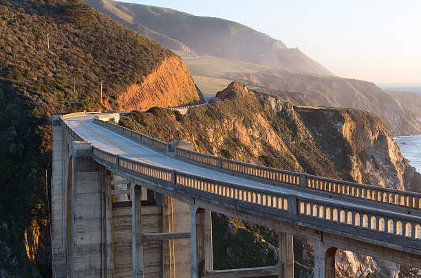istock Arch bridge on winding coastal highway 469416606