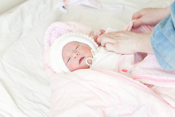 istock Dressing a newborn baby 469420126