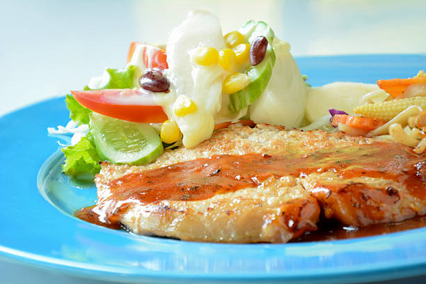 istock Pan fried pork steak with mix vegetable salad 469436816