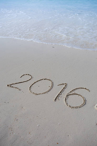 istock Numbers 2016 on beach - concept holiday background 469438300