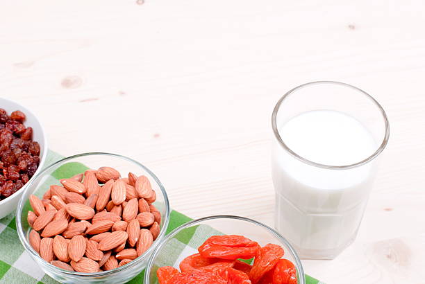 istock milk, almonds, raisins, dried apricots on the table top view 469440724