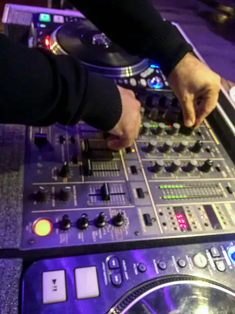 Photo of Closeup wiev of DJ working in night club