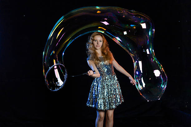 istock Girl is showing soap bubbles show 469445280