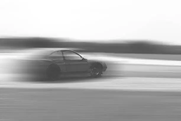 drift car motion blur on vintage black and white