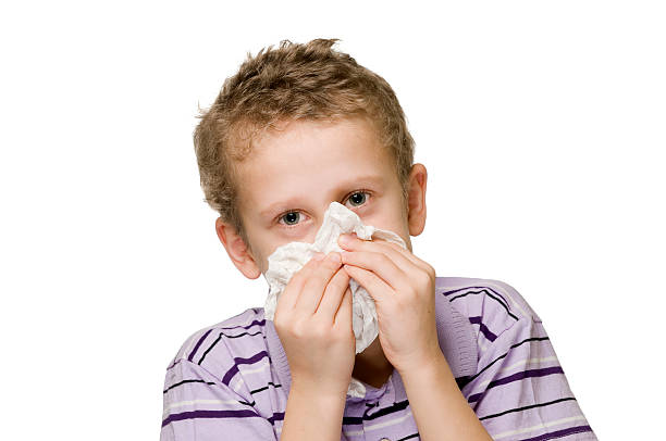 boy blow nose two hands stock photo
