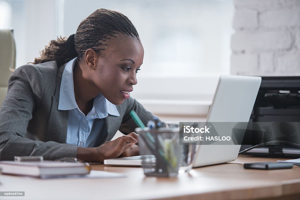 African business woman working Pretty african business woman working on laptop in office Adult Stock Photo