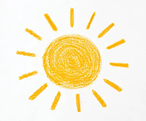 Child Drawing of orange sun which was drawn with a yellow crayon on white background.