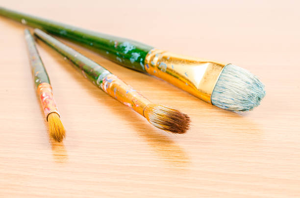 istock artist paintbrush on wooden table 469451032