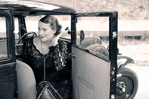 Photo of Woman in a Vintage Car