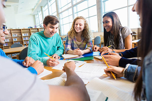 istock Diverse group of high school teenage students studying in library 469455264