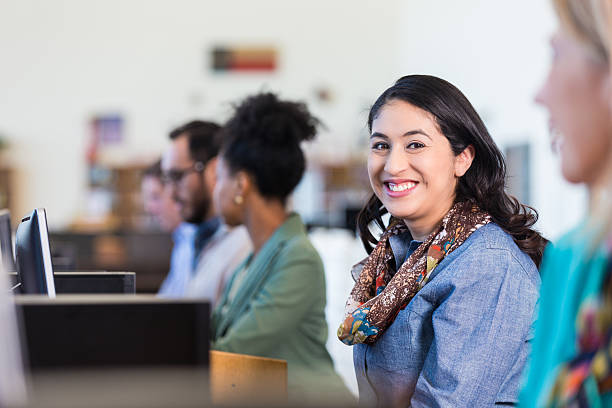 istock Pretty Hispanic mid adult woman is taking college computer class 469455266