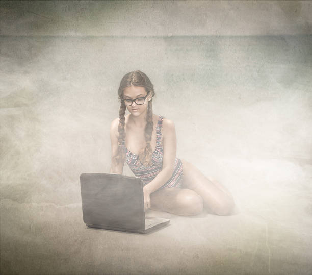 istock nerd girl networking on the beach 469455532
