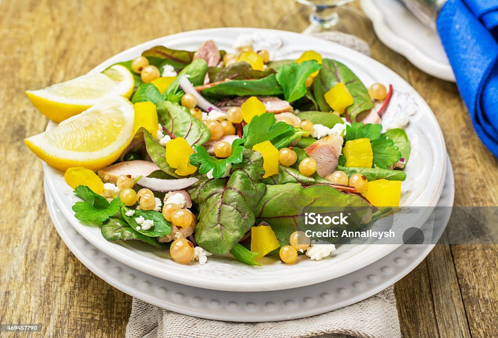 Assorted salad with arugula, spinach, chard, chicken, white currant berries Assorted salad with arugula, spinach, chard, chicken, white currant berries, pineapple, purple sweet onions and feta cheese. selective Focus Chard Stock Photo