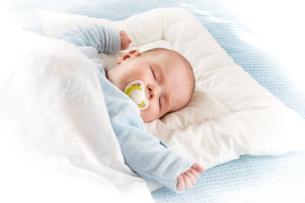 istock baby sleeping on blue blanket 469461624