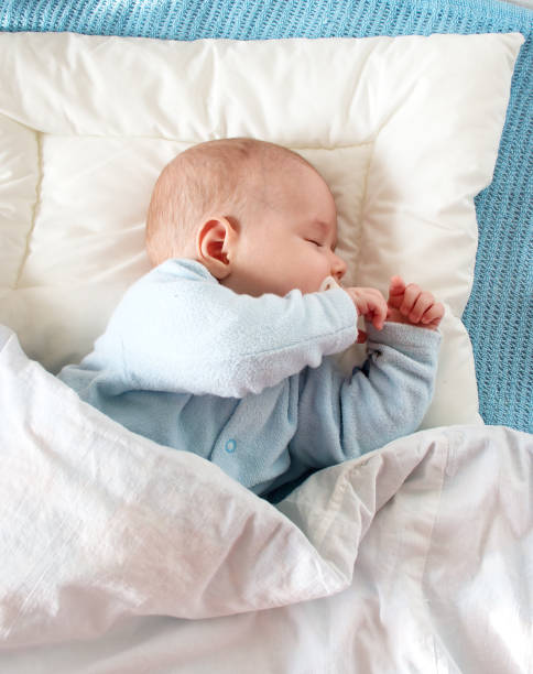 istock baby sleeping on blue blanket 469461638